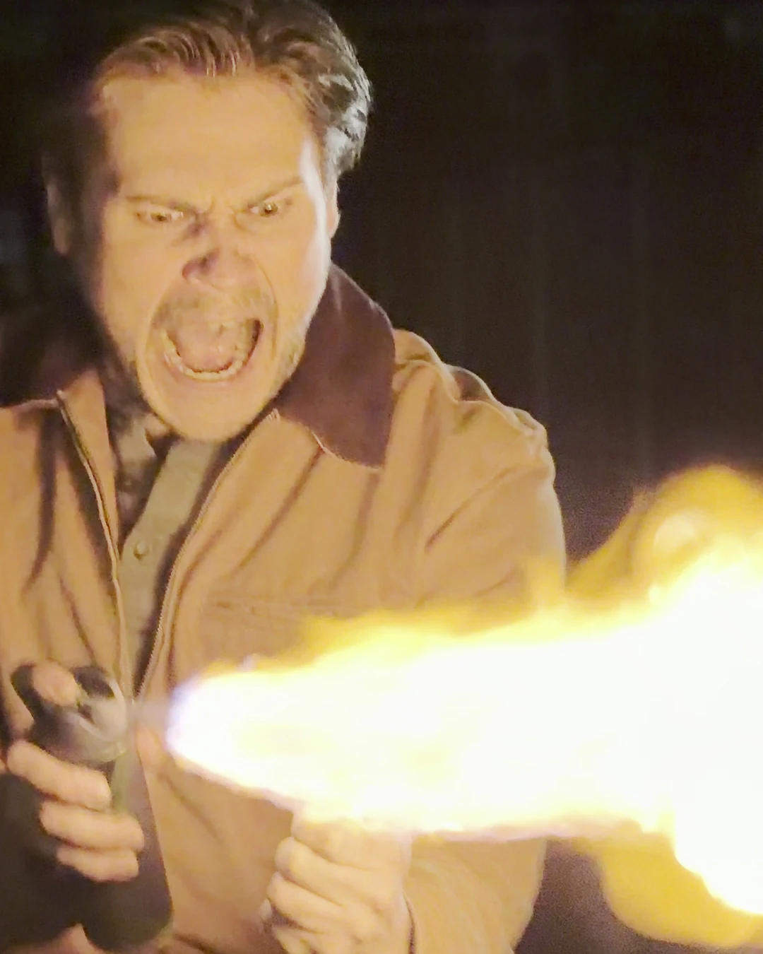 Actor roaring as a jet of flame bursts from his hands on a dark London street, a frame from Lime Bike: The Movie