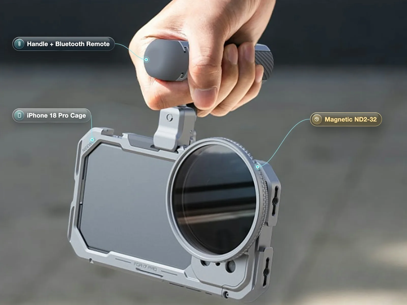 Hand holding an iPhone 18 Pro cage by its top handle, with a Bluetooth remote grip and a round magnetic ND filter over the lenses