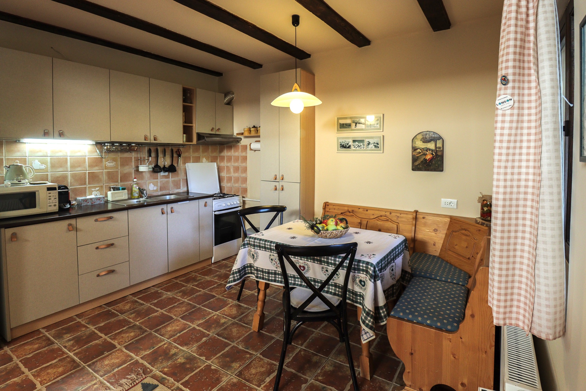 Dining area with table and chairs near the terrace access