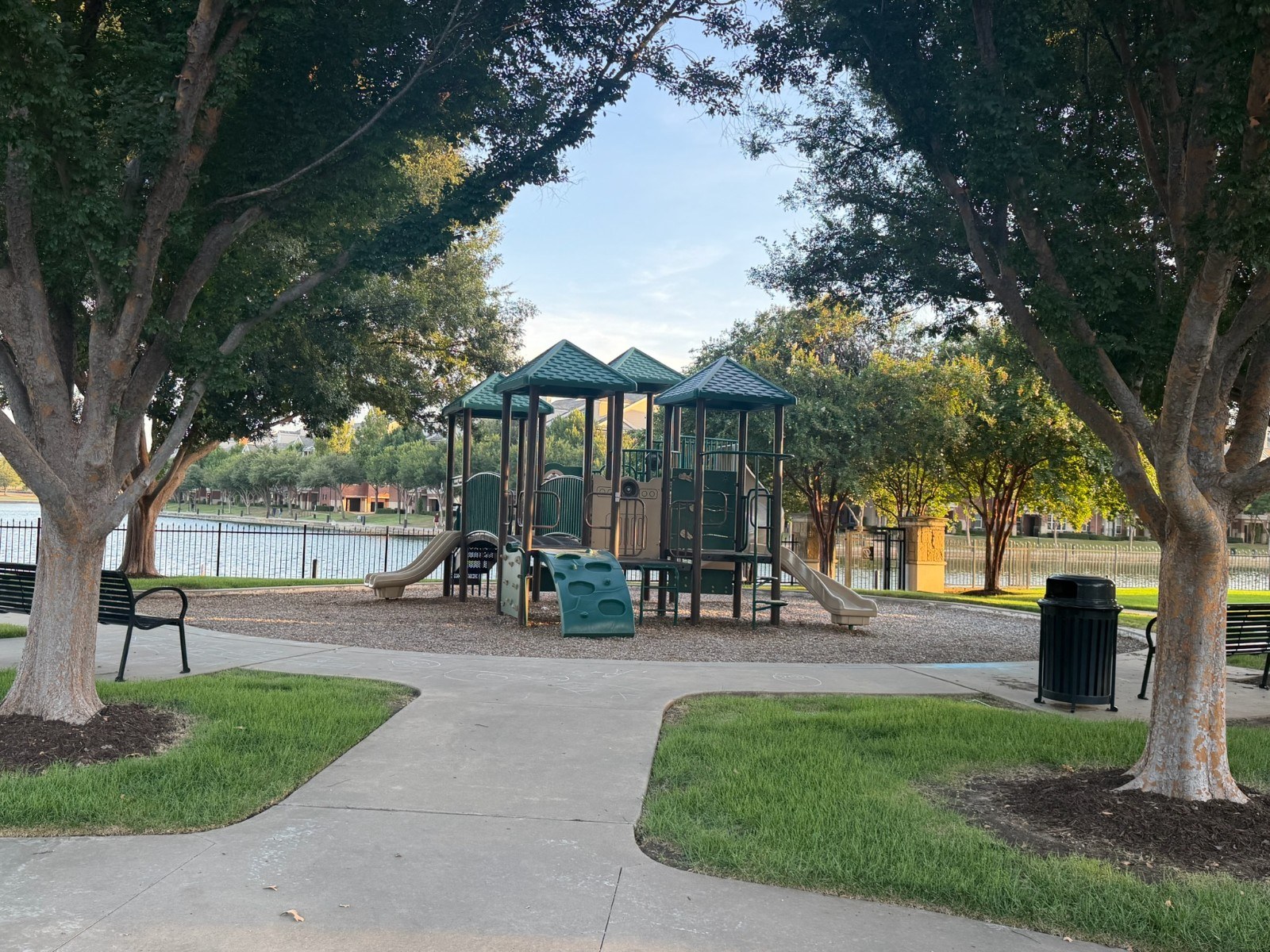Refined community amenity terrace with pool, pavilion, lounge seating, and landscaping
