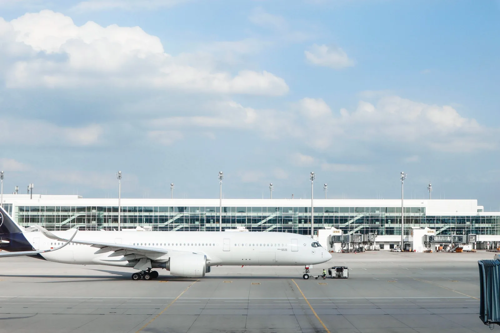 Avião comercial estacionado na pista de um aeroporto moderno, ilustrando a otimização de rotas e o uso de tecnologia preditiva na aviação.