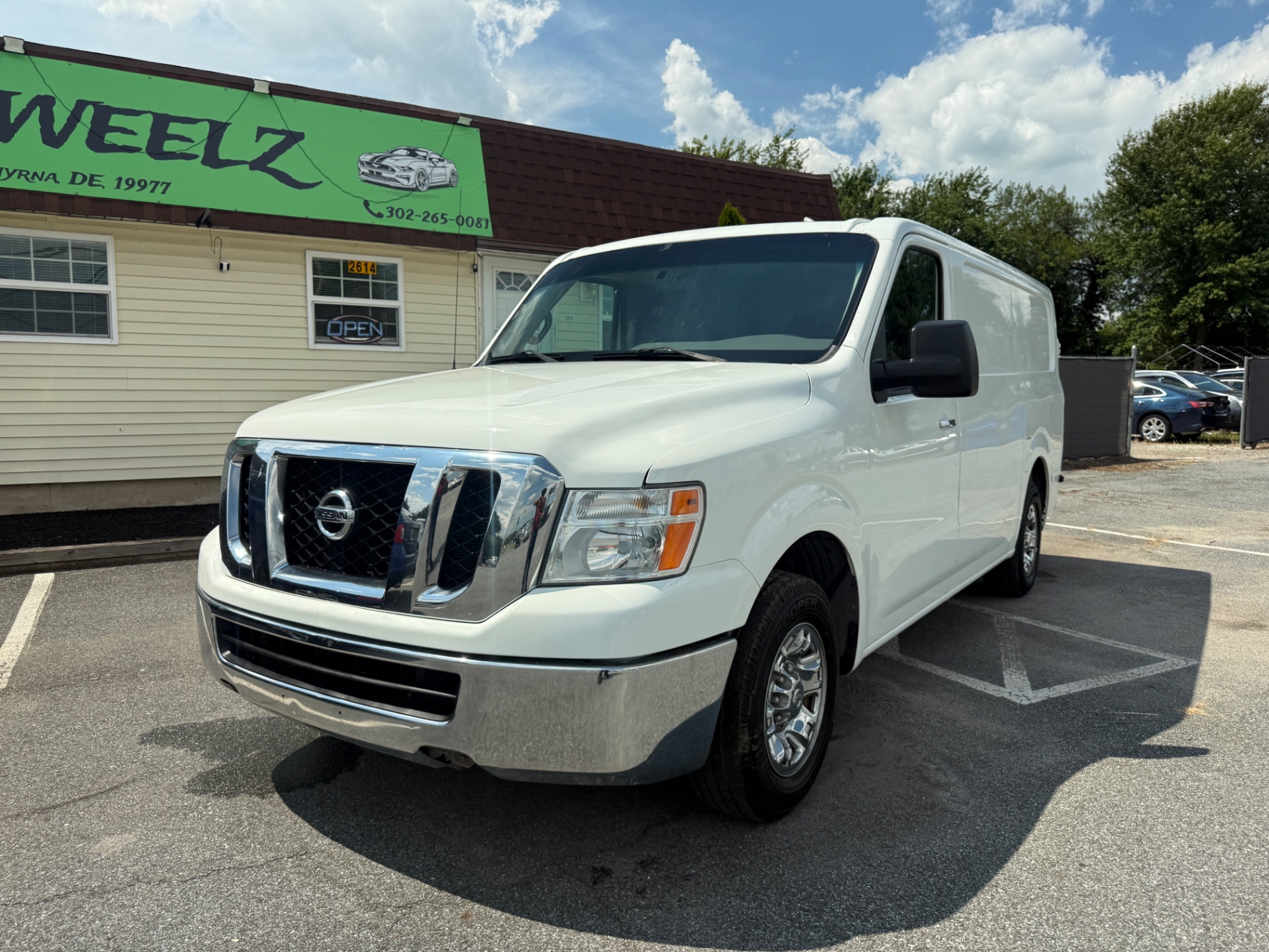 2015 Nissan NV 2500 HD SV Cargo — rebuilt & branded title, 19% below market