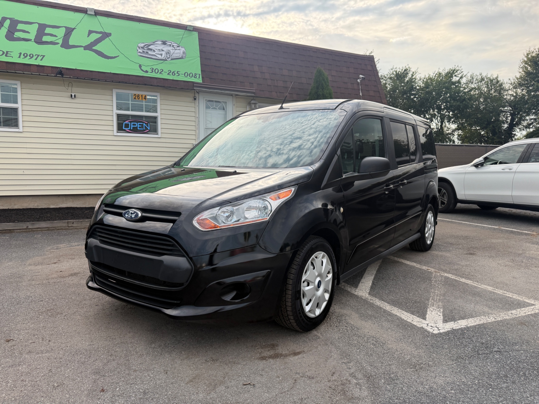 2014 Ford Transit Connect XLT — rebuilt & branded title, 11% below market