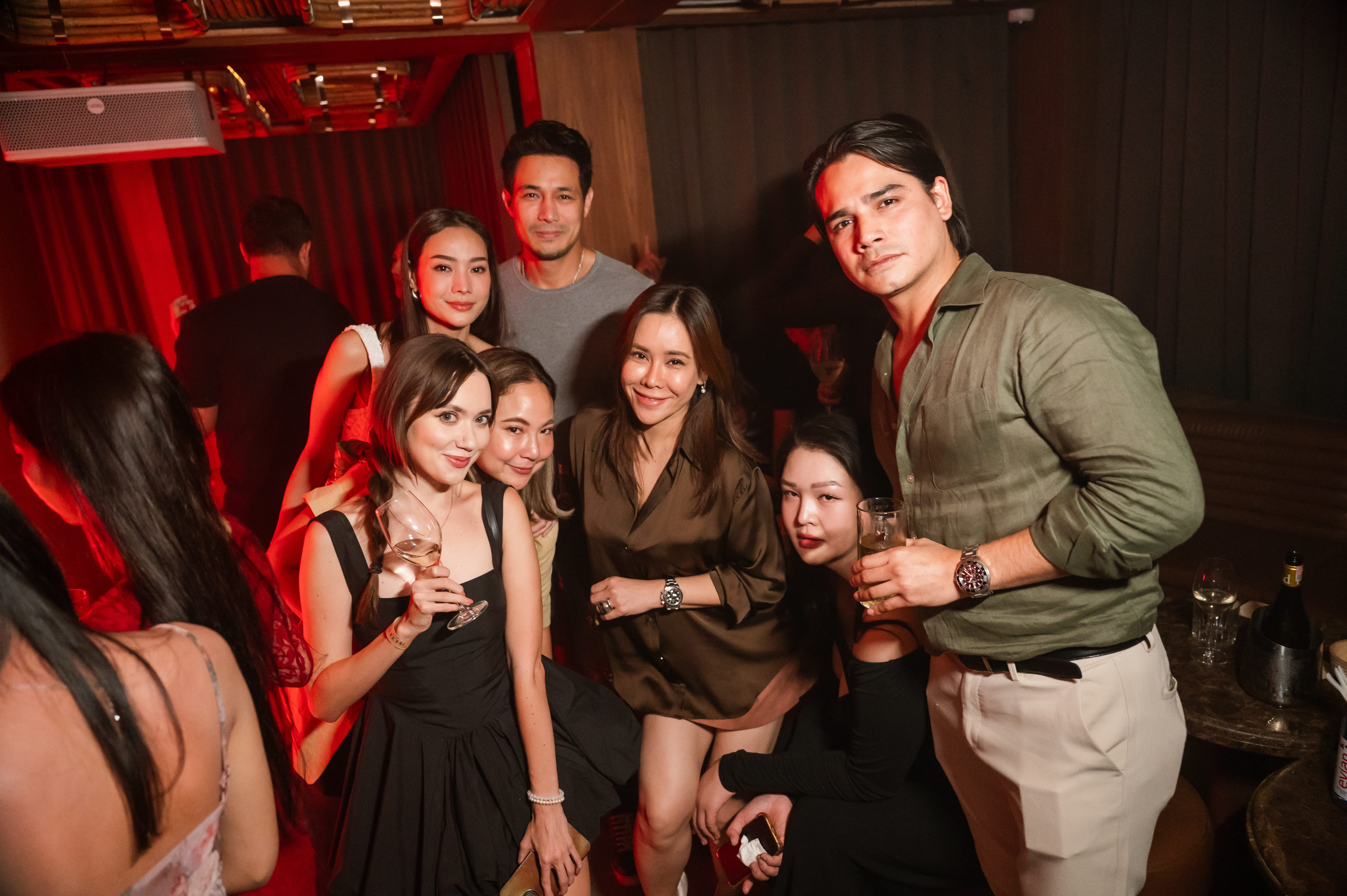 A group of friends having fun in a bar with cocktails