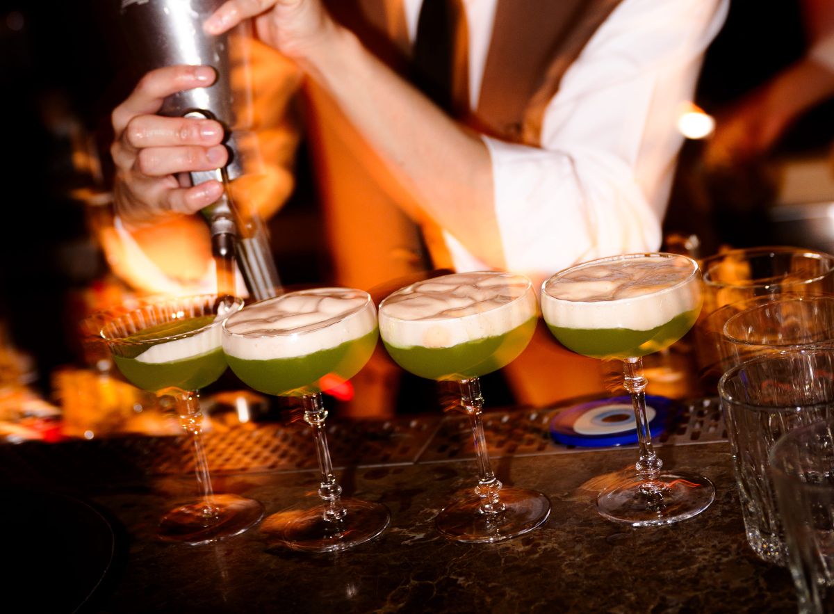 lineup of craft cocktails in clear glasses