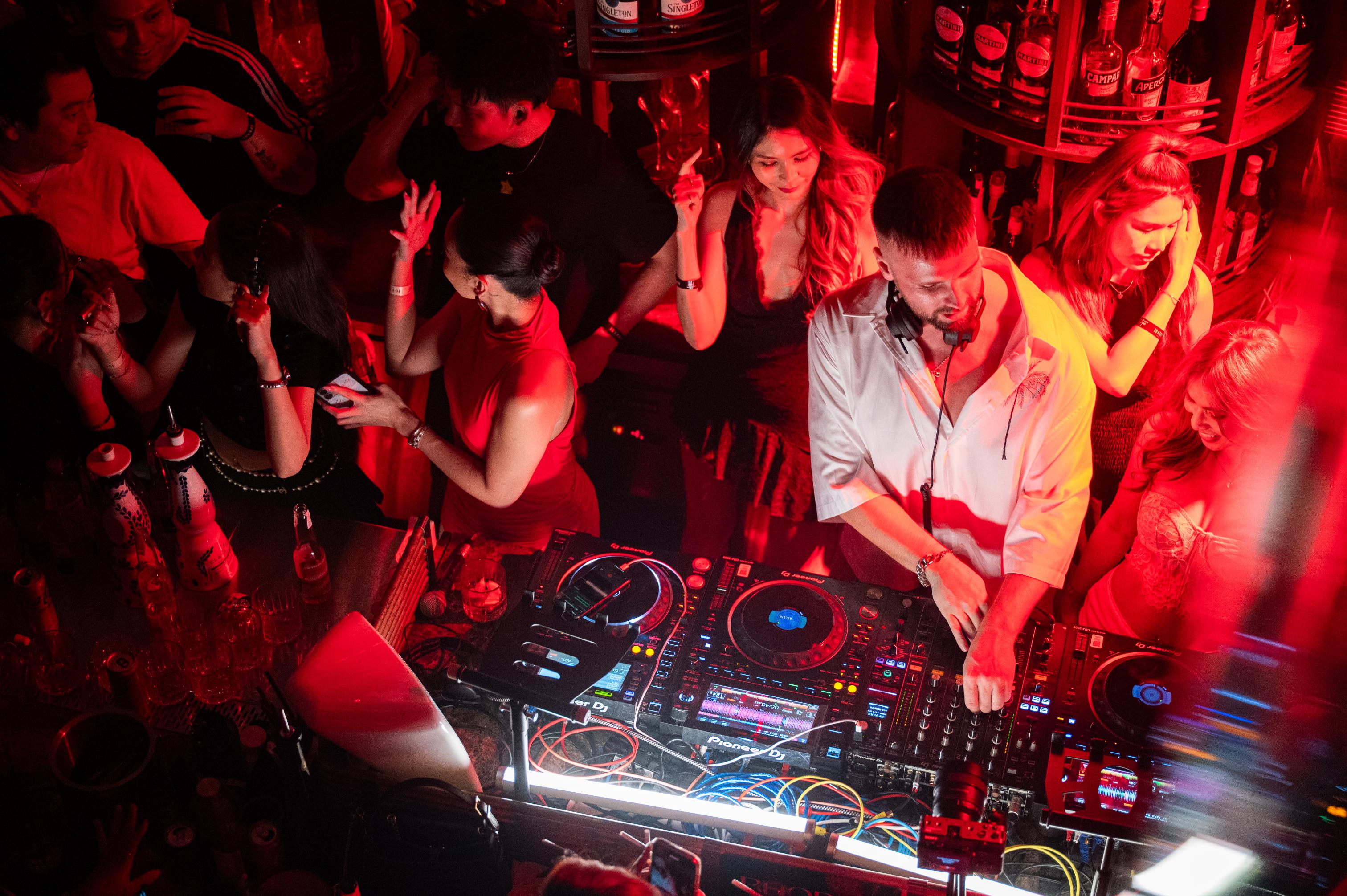 a group of people dancing in the DJ Booth