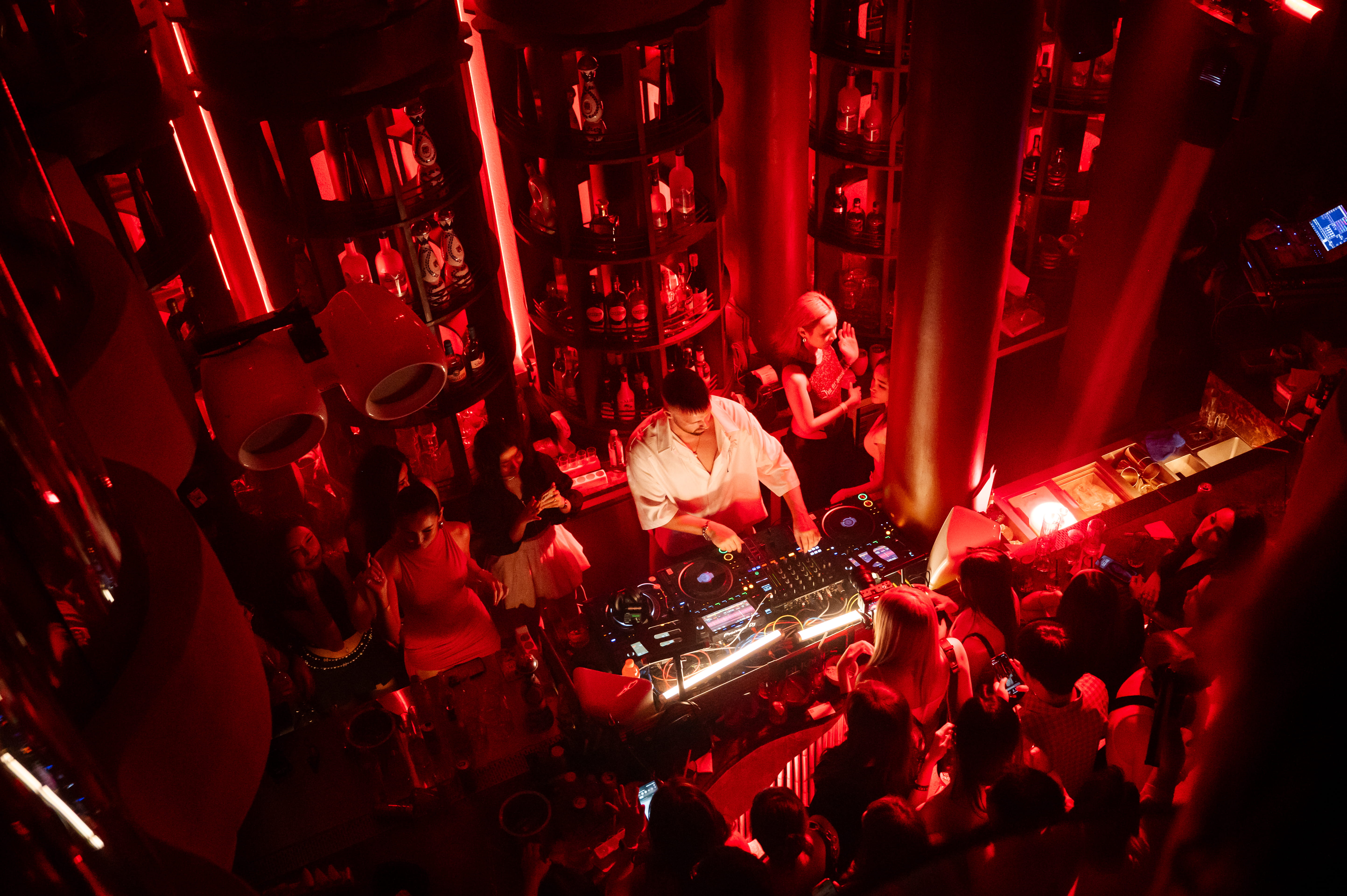 A DJ playing to a dancing crowd at Rhodes - one of the best techno clubs in Bangkok