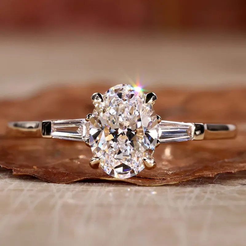 Oval Diamond Engagement Ring, Side Baguette Three Stone Ring oval cut engagement ring in platinum