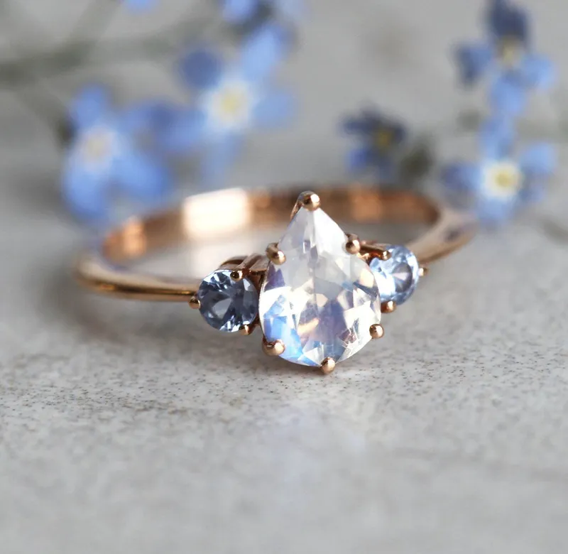 Pear Rainbow Moonstone Ring With Light Blue Sapphires view 3