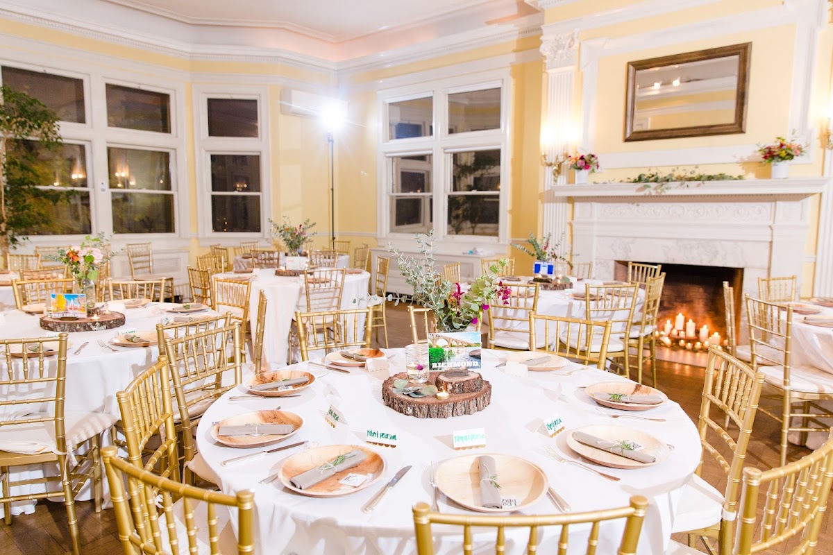 Josephine Butler Parks Center — a reception set with gold chairs beside a fireplace