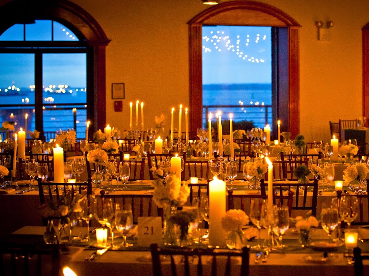 The Liberty Warehouse, Red Hook — a candlelit reception with arched windows onto New York Harbor