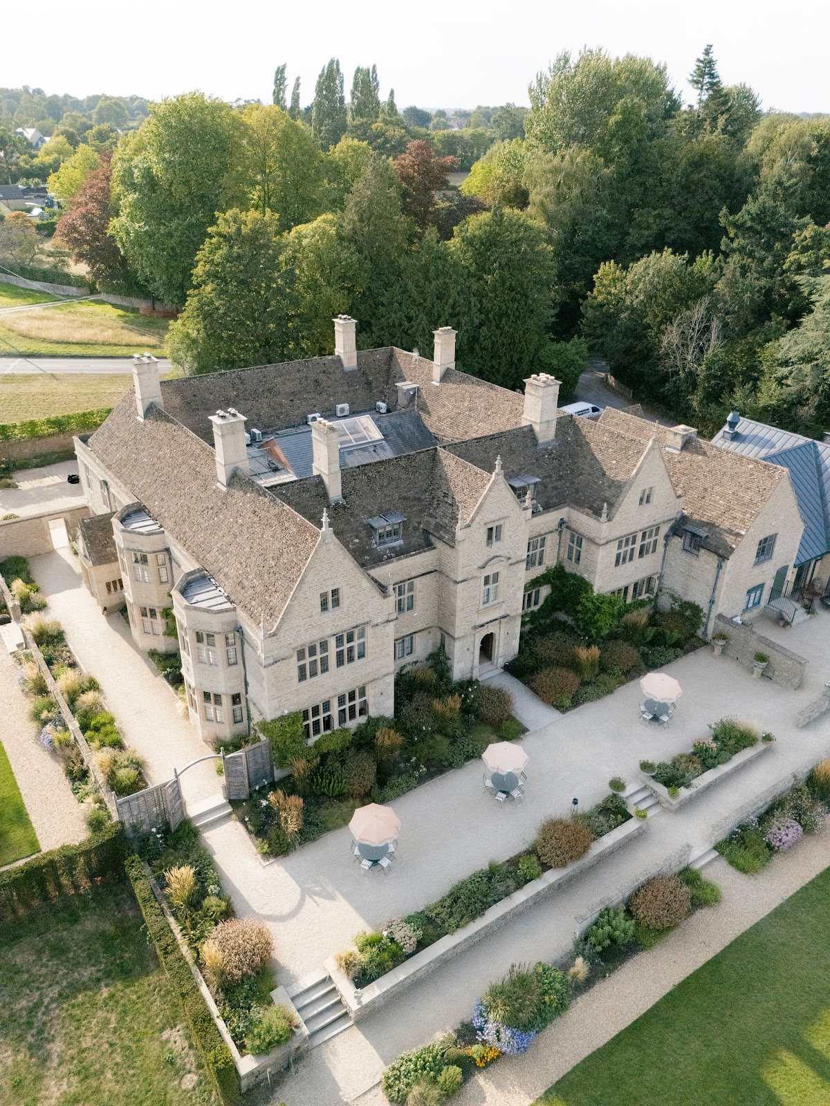 Kin House, Wiltshire — an aerial view of the stone house, terraces, and gardens