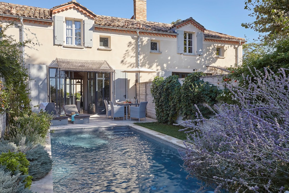 Château Les Carrasses — restored 1886 wine estate wedding venue near Béziers in the Languedoc with an Eiffel-designed glass conservatory, infinity pool, and exclusive-use for 90 guests
