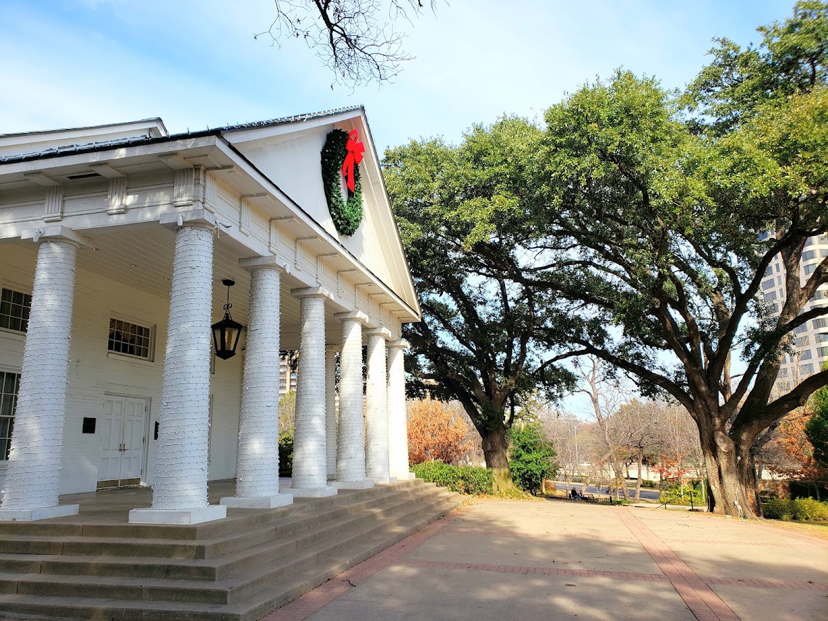 Arlington Hall, Turtle Creek Park — the white columns of the historic hall beneath a live oak