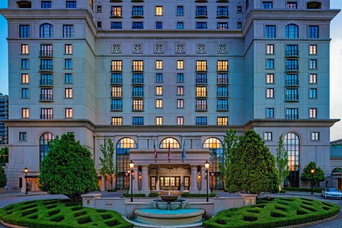 The St. Regis Atlanta, Buckhead — the hotel's facade and formal garden lit at dusk