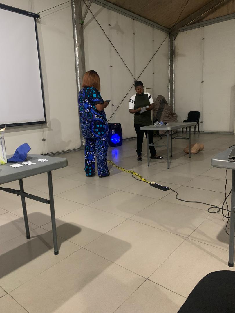 Training venue setup with CPR manikin and projection screen