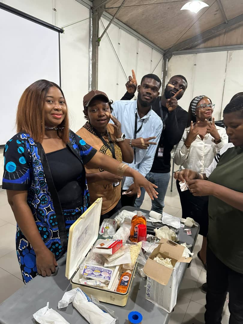 Group photo of trainees with first aid supplies and equipment