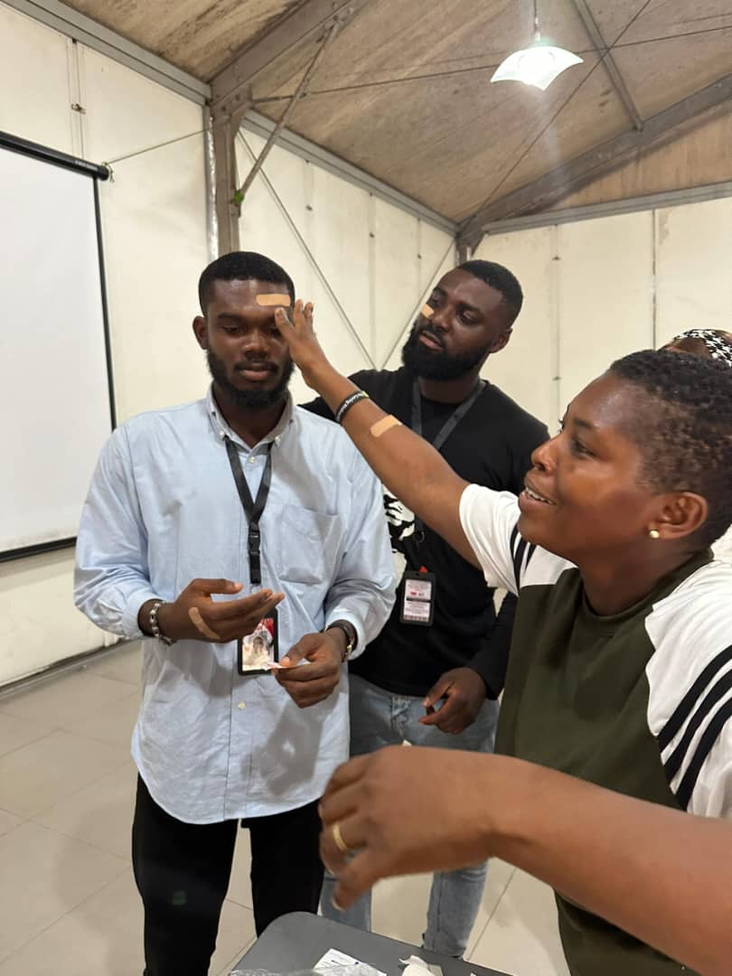 Wound dressing practice — applying bandage to simulate head injury