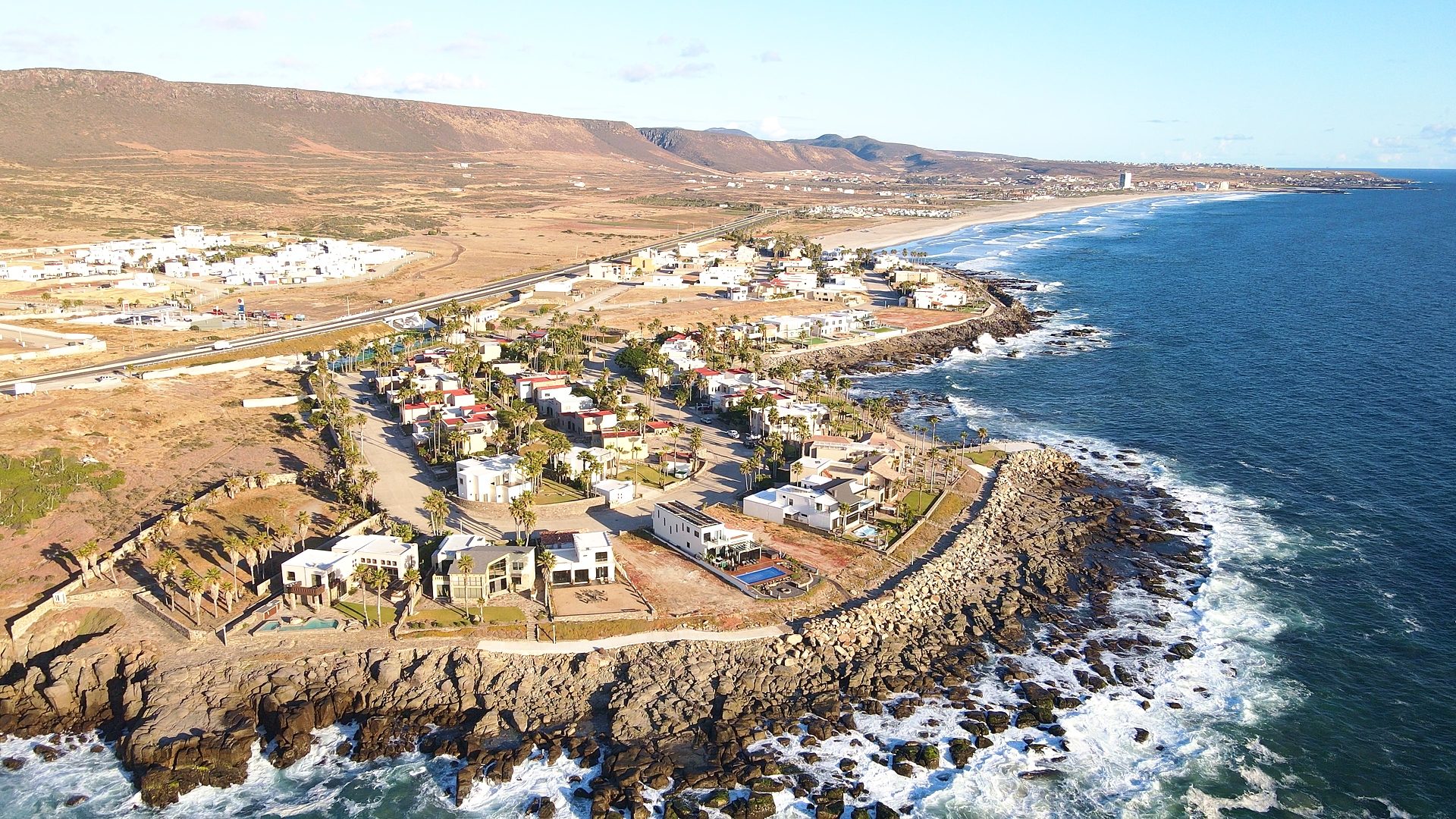 Scenic Baja California coastal highway winding along Pacific Ocean cliffs between Rosarito and Ensenada