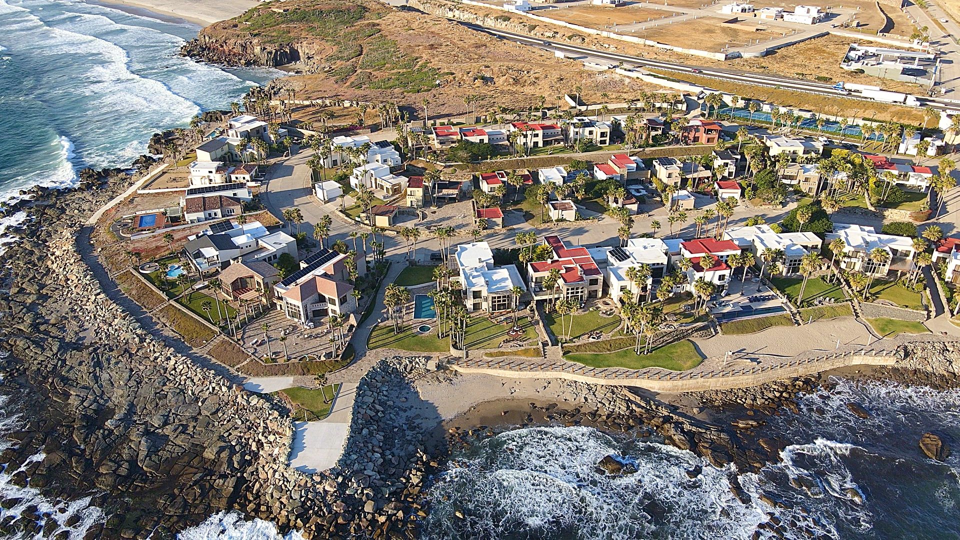 Oceanfront boardwalk malecón with Pacific Ocean views and coastal landscaping in Baja California