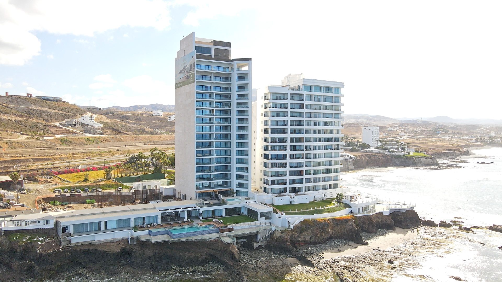 Luxury penthouse living room with floor-to-ceiling glass and Pacific Ocean views in Rosarito Beach