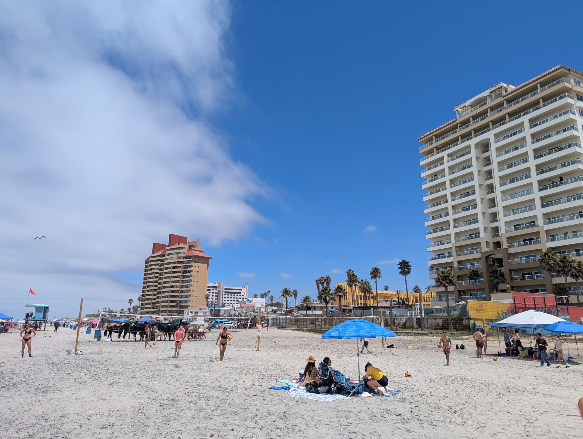 Beach volleyball players competing on Pacific Ocean sand in Rosarito Beach, Baja California