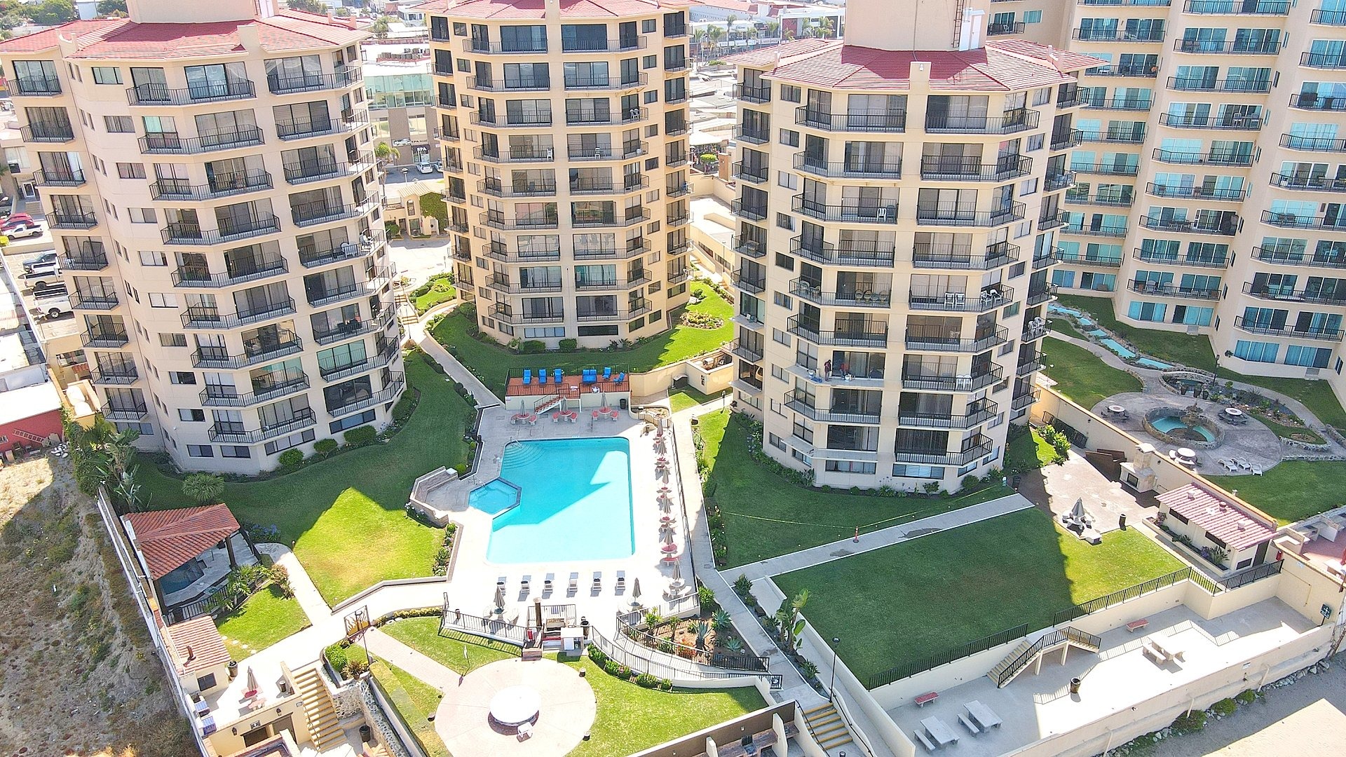 Aerial view of a gated beachfront community with amenities in Rosarito Beach