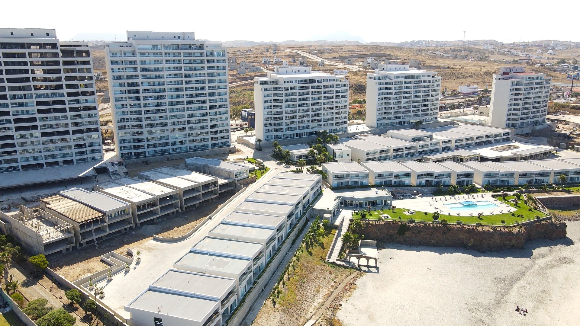 Luxury condo building with swimming pool in a Rosarito Beach gated community