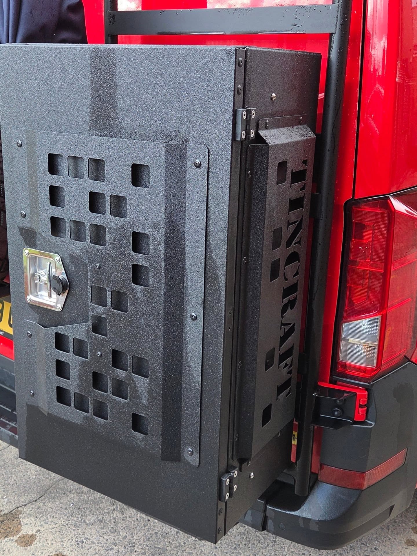 Aluminium rear door storage panel with cut-out Tincraft lettering on a VW Crafter camper
