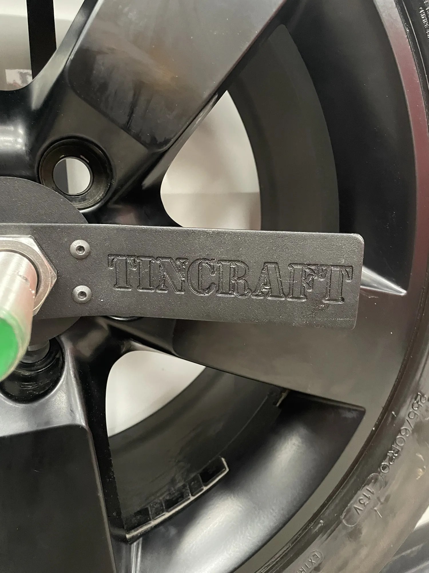 Close-up of the Tincraft name engraved into the alloy wheel of a MAN TGE camper