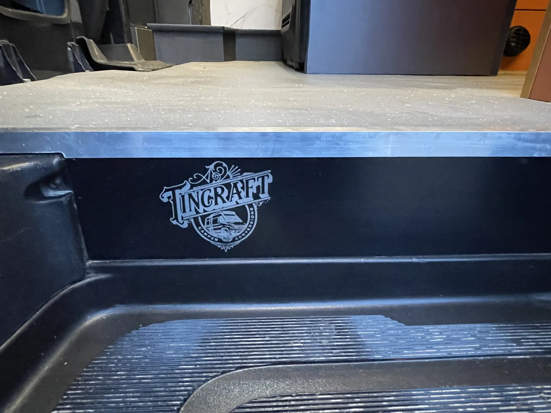 Engraved metal sill plate at the side step of a Sprinter campervan