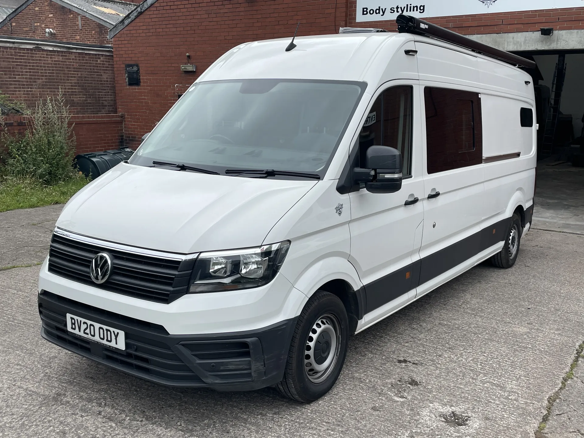 White VW Crafter campervan conversion, front three-quarter view on a driveway