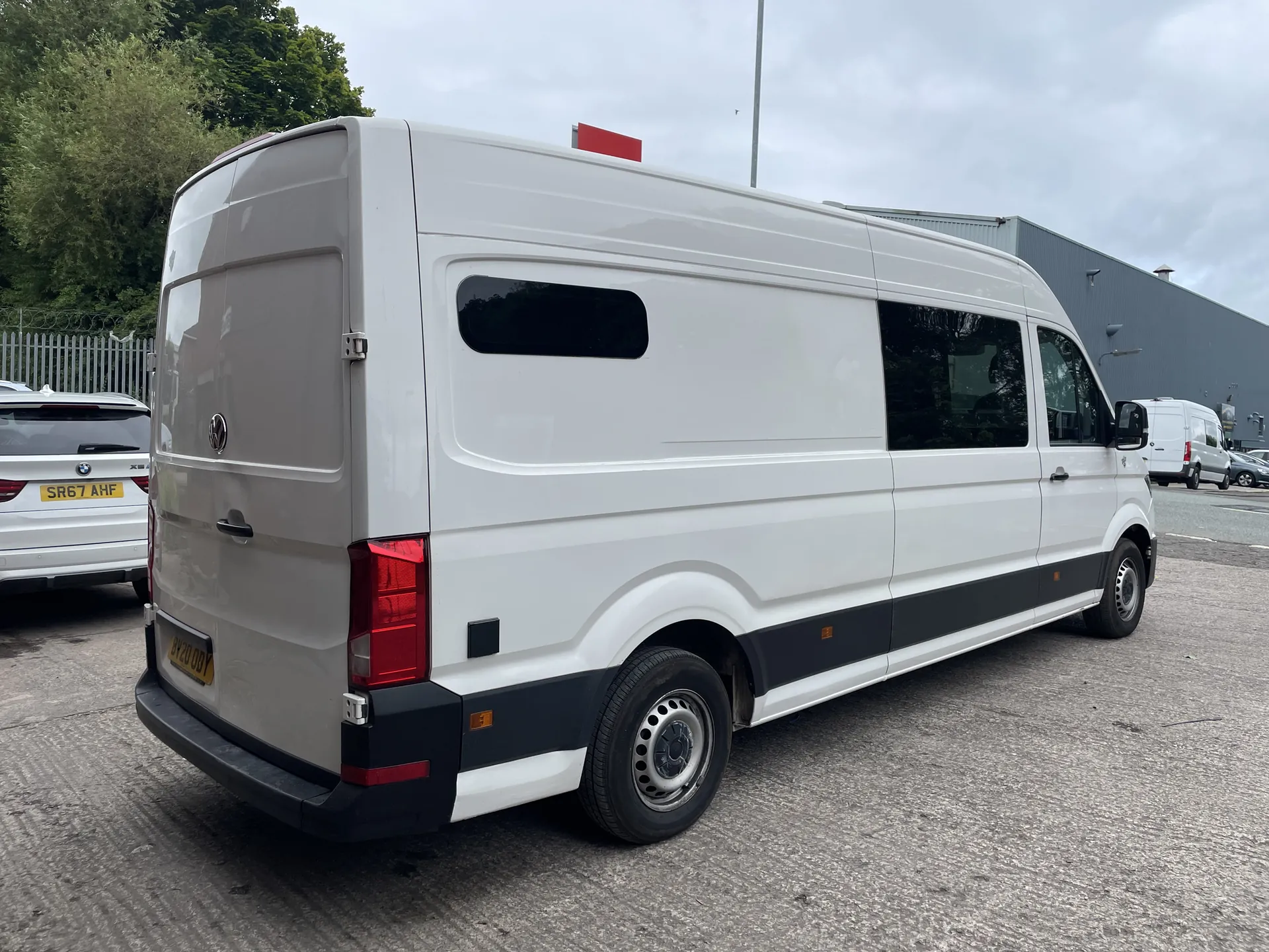 Rear three-quarter view of a white VW Crafter campervan conversion