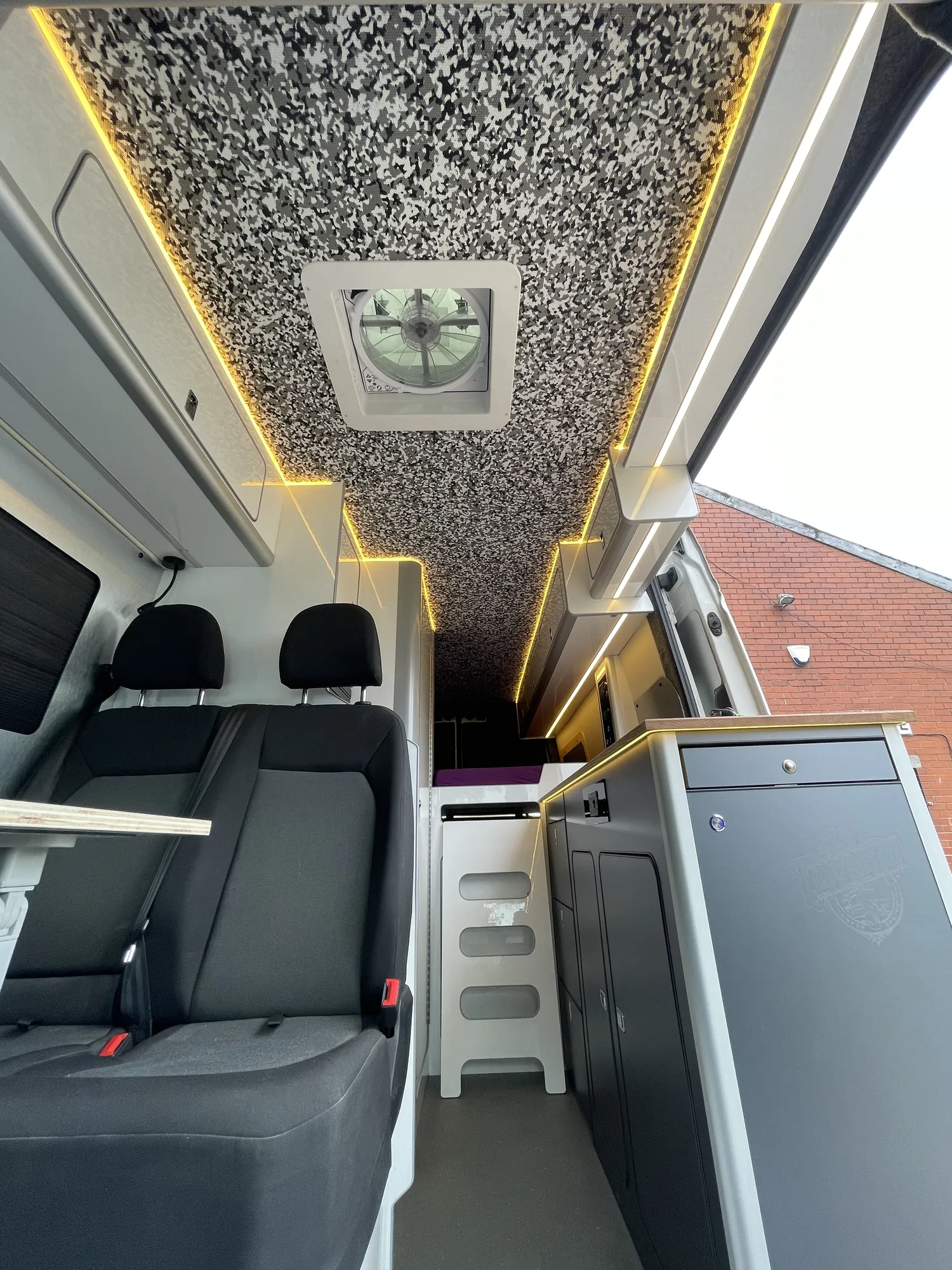 VW Crafter camper interior looking forward along an LED-lit ceiling