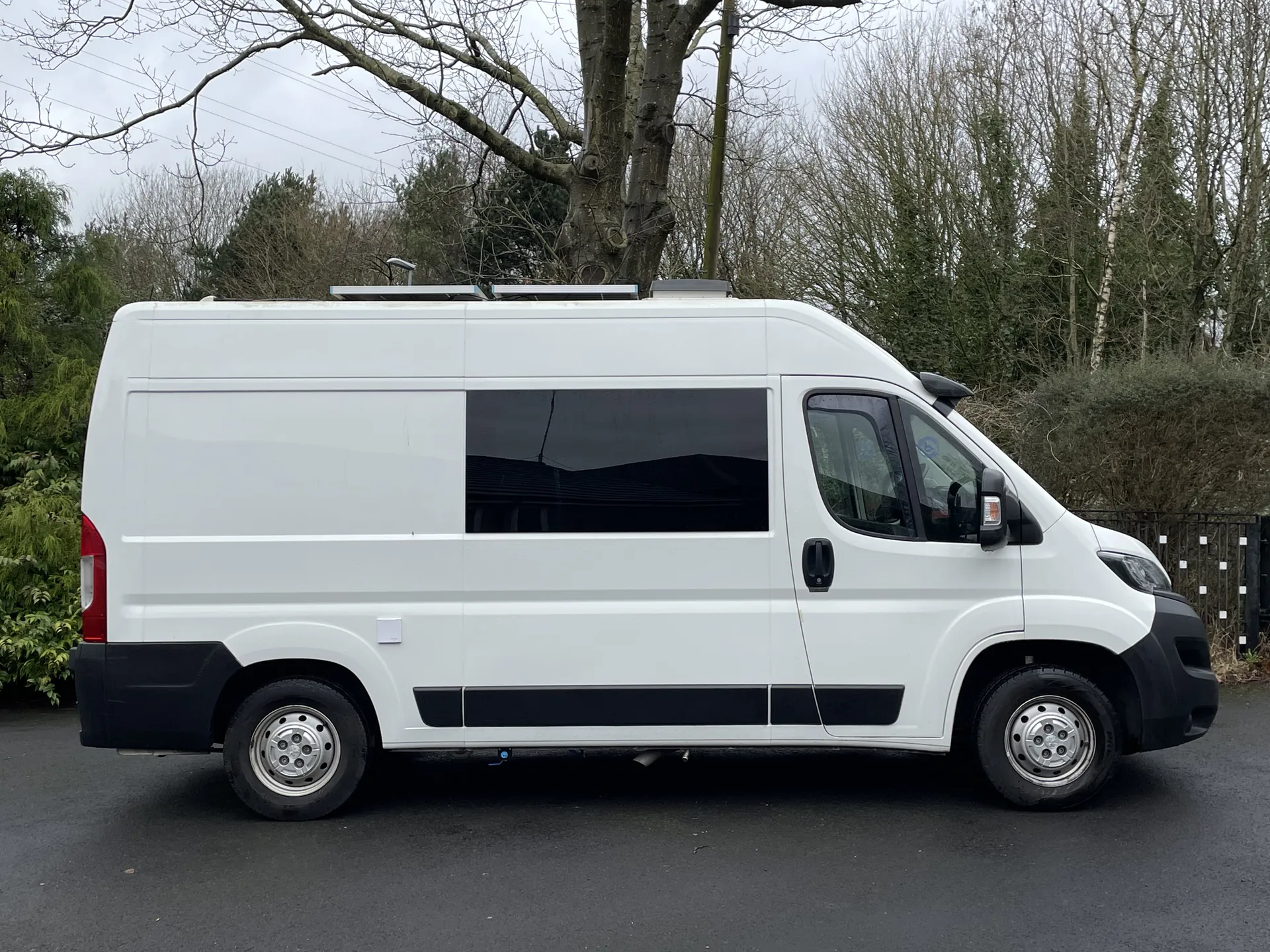 Side profile of a white Peugeot Boxer L2H2 campervan conversion