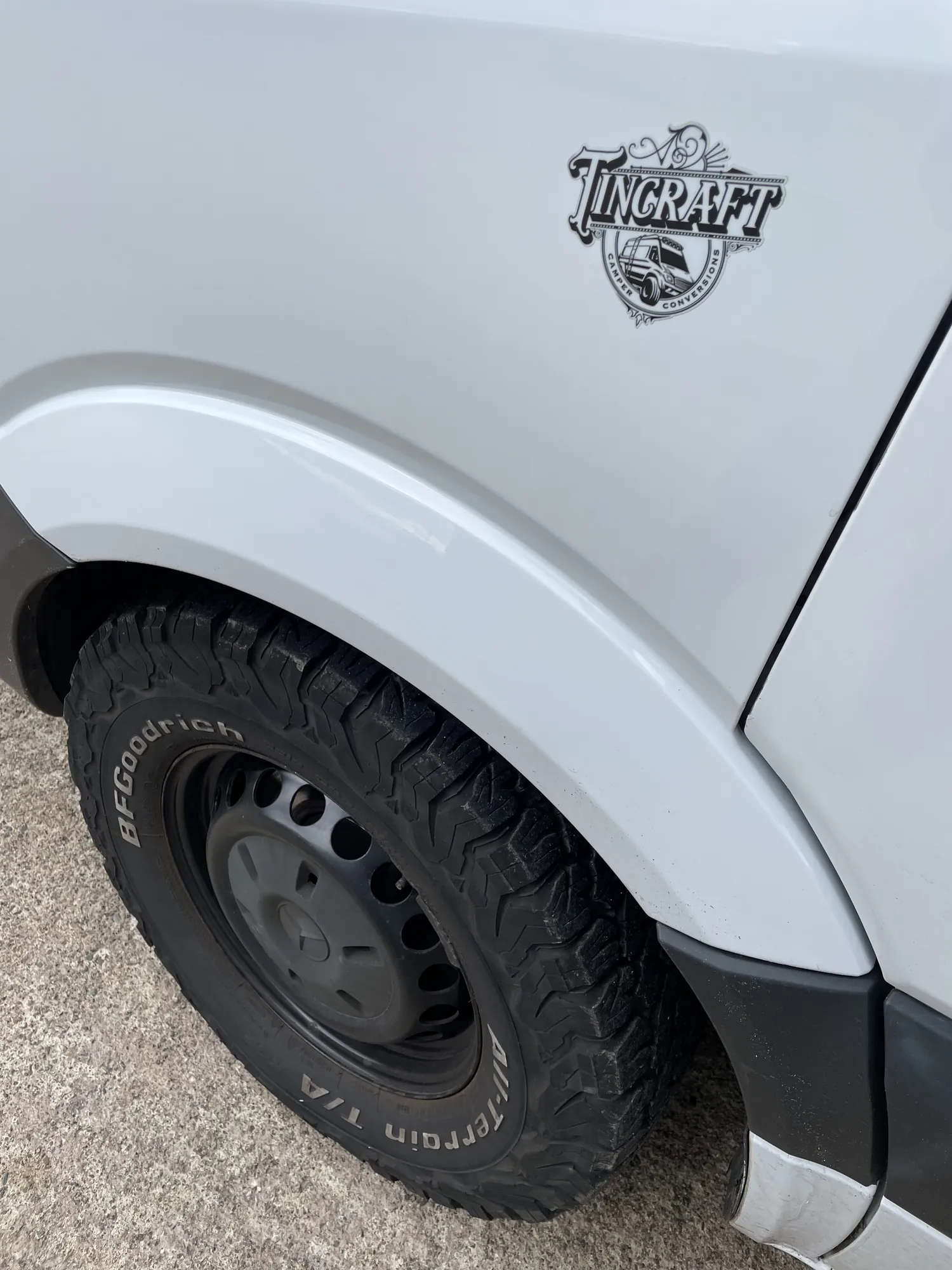 Tincraft body badge above an all-terrain tyre on a Mercedes Sprinter camper