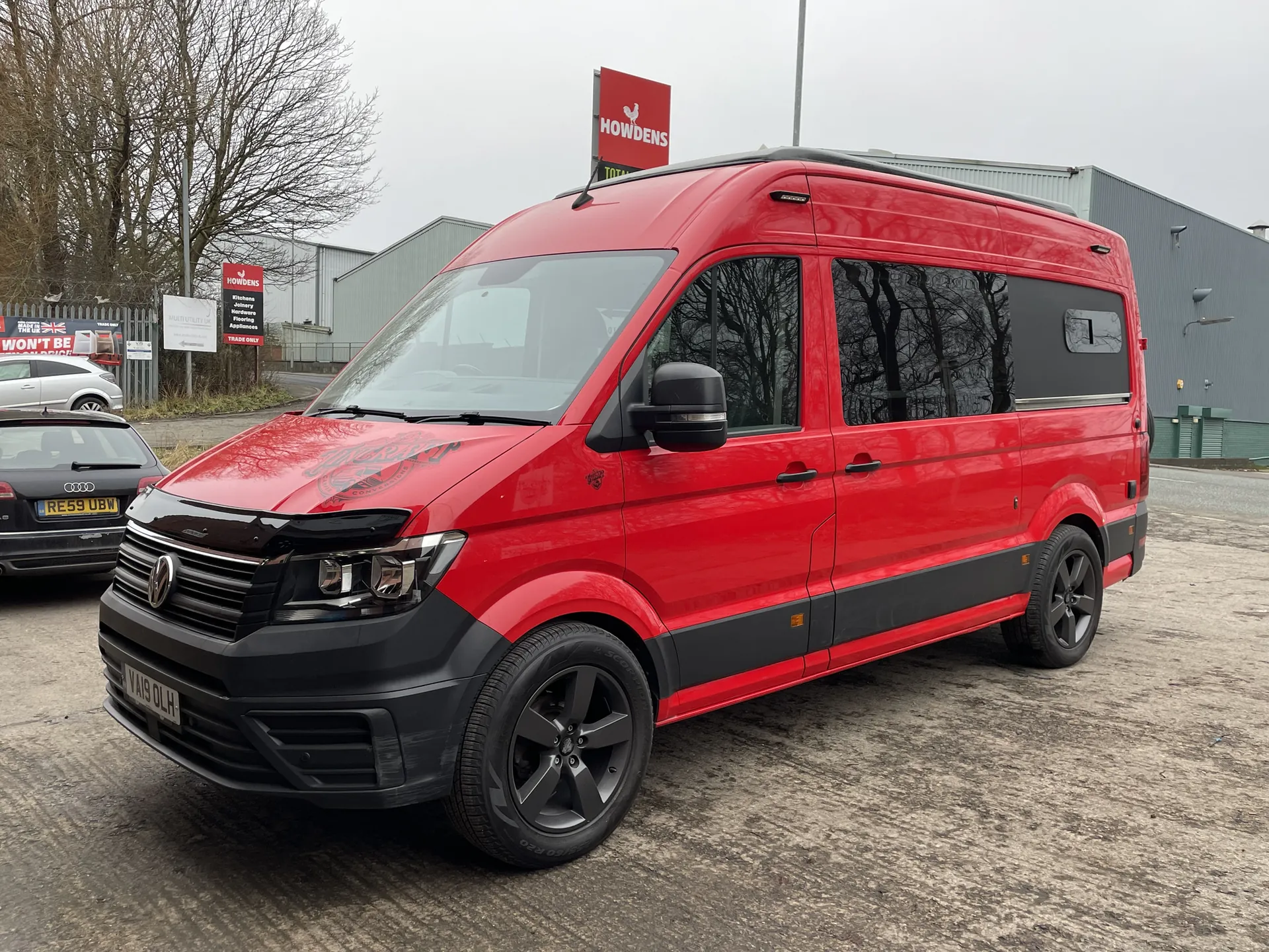Red VW Crafter camper conversion photographed outdoors from the front
