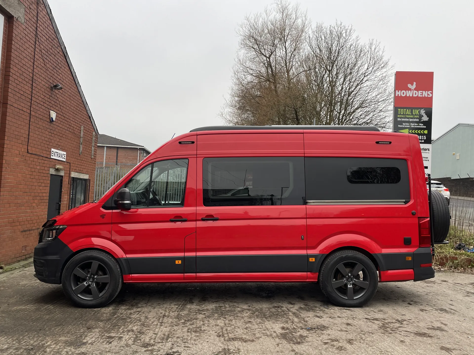 Side profile of a red VW Crafter LWB campervan conversion