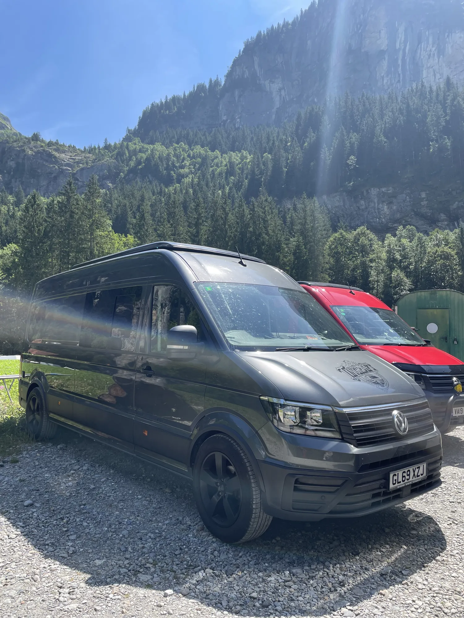 Side profile of a grey VW Crafter conversion with mountains behind