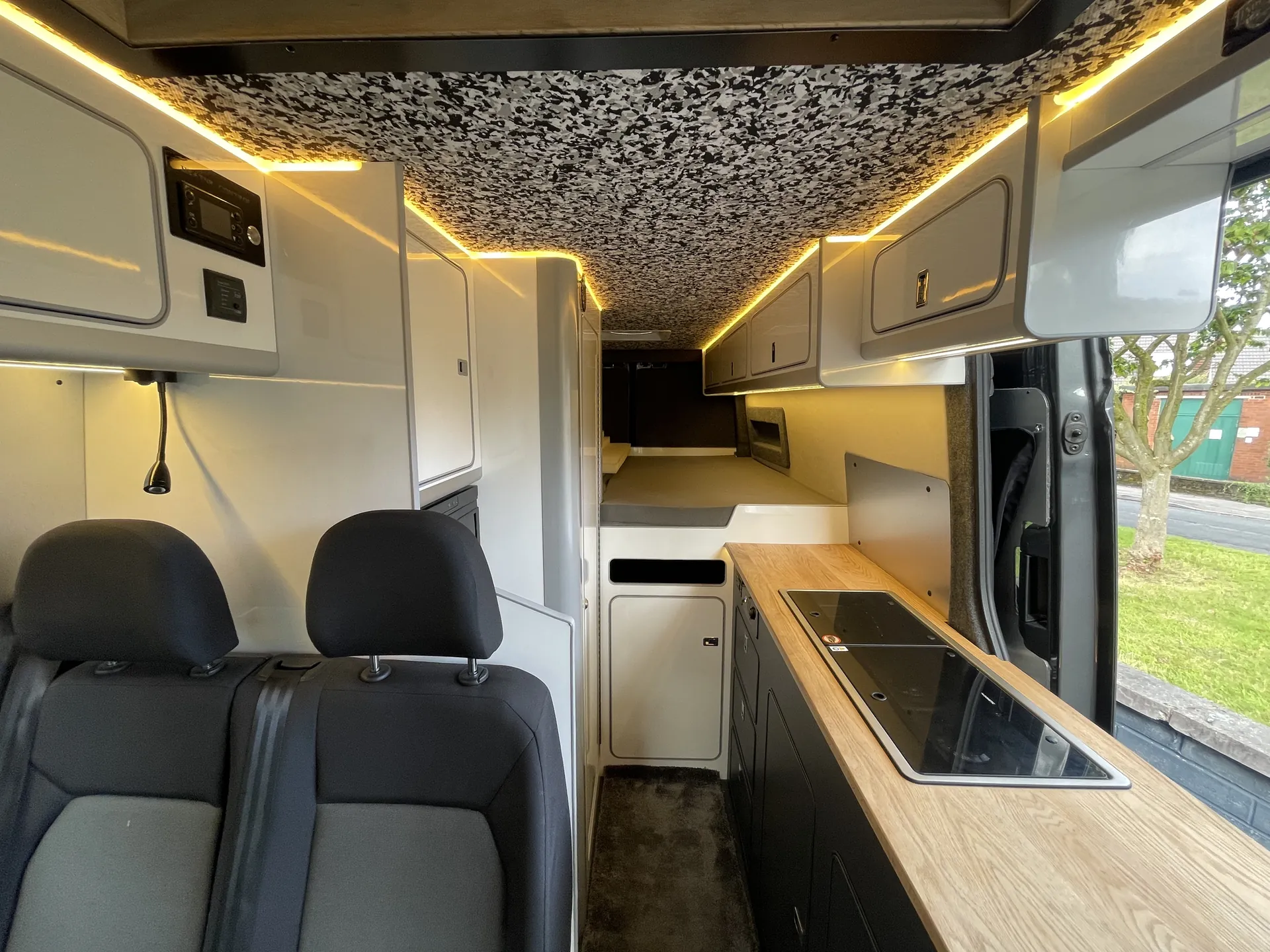 Galley with oak worktop and hob in a VW Crafter campervan conversion