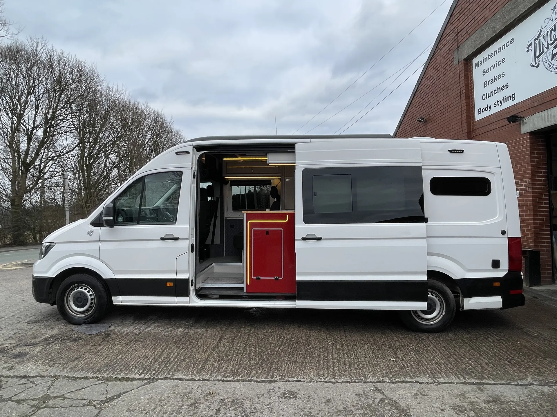White VW Crafter camper conversion side-on with the sliding door open