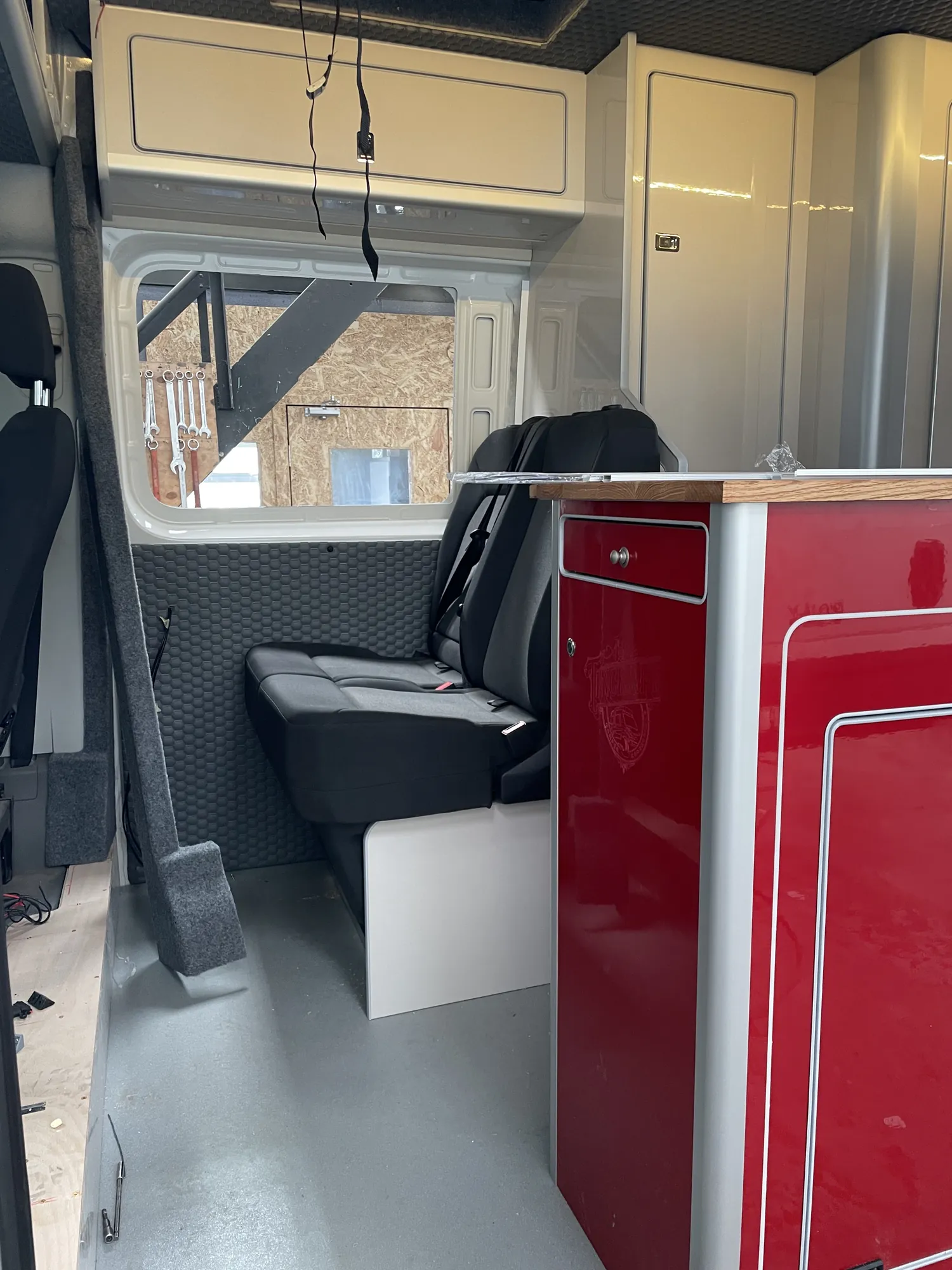 Swivel seat beside a window inside a VW Crafter camper conversion