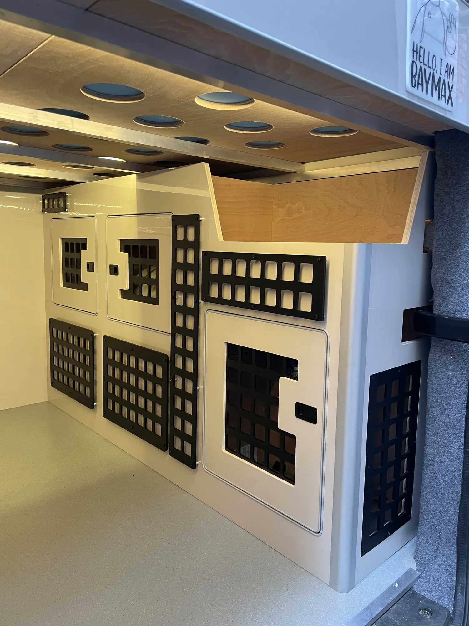 Perforated storage panels and overhead lockers in a VW Crafter conversion