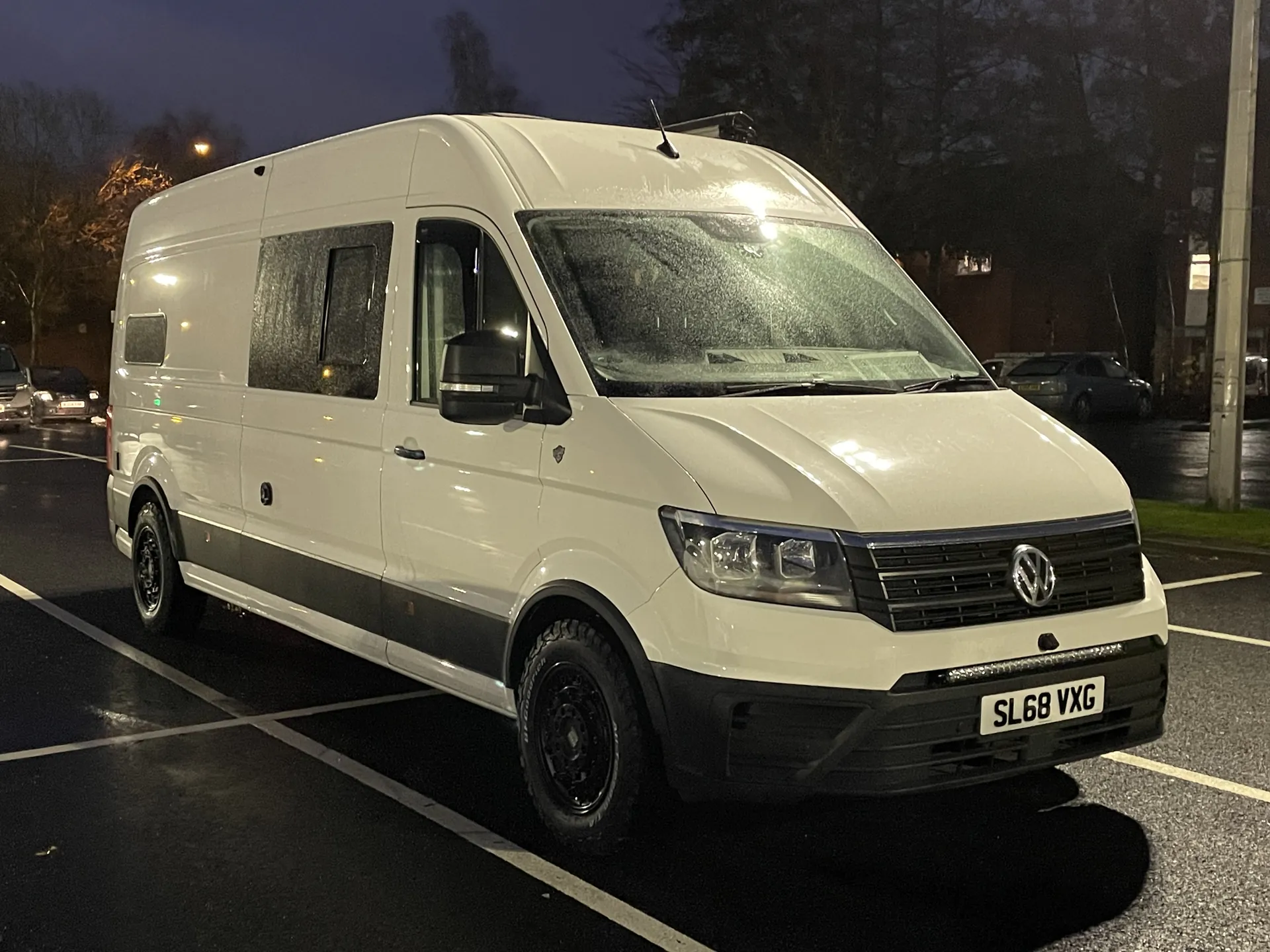 White VW Crafter campervan conversion, front three-quarter view with black wheels