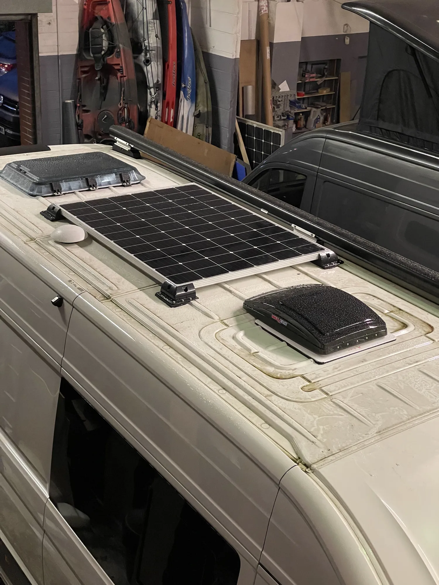 Roof of a VW Crafter conversion with a solar panel and rooflights