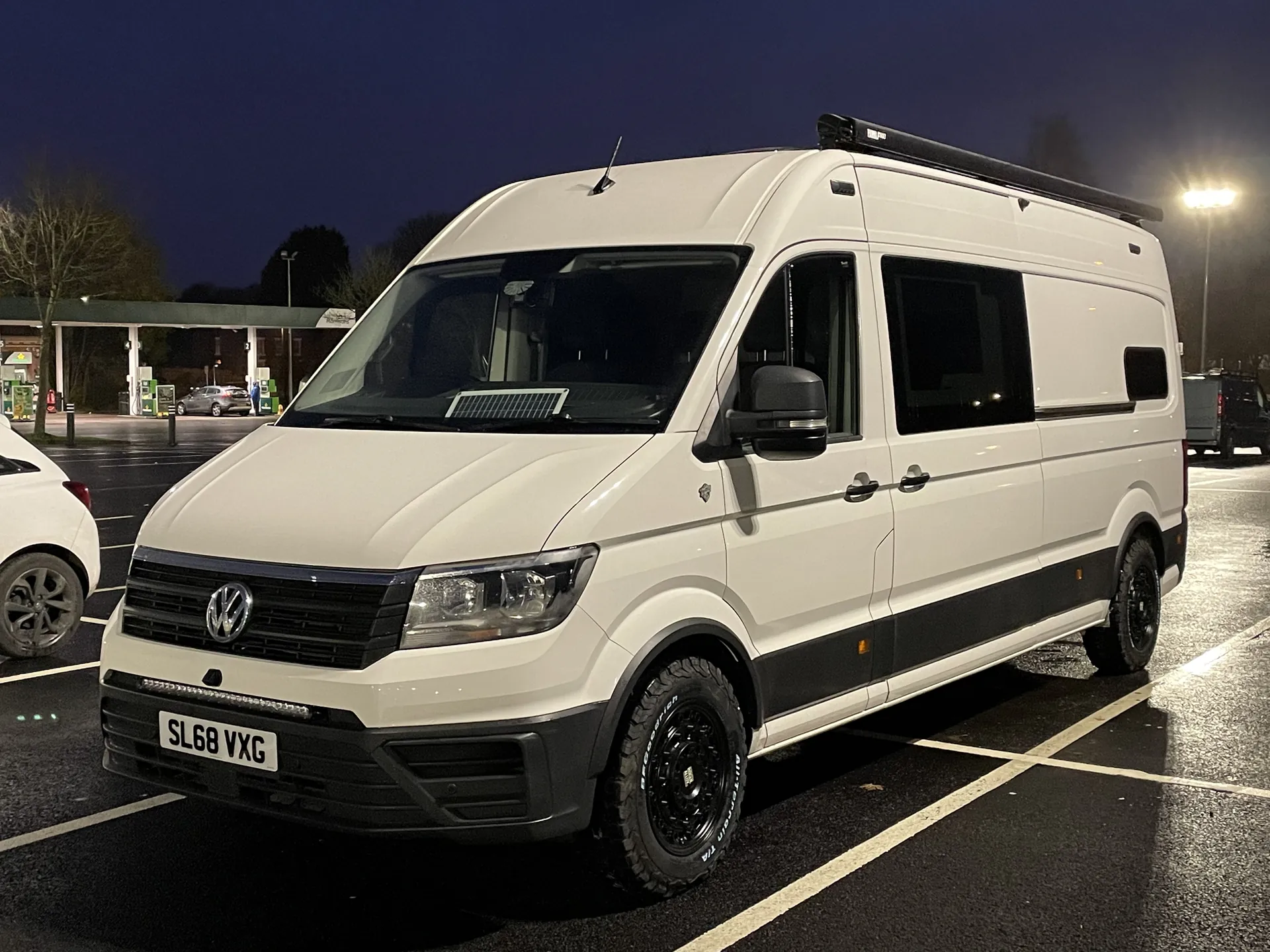 White VW Crafter camper photographed at night under street lighting
