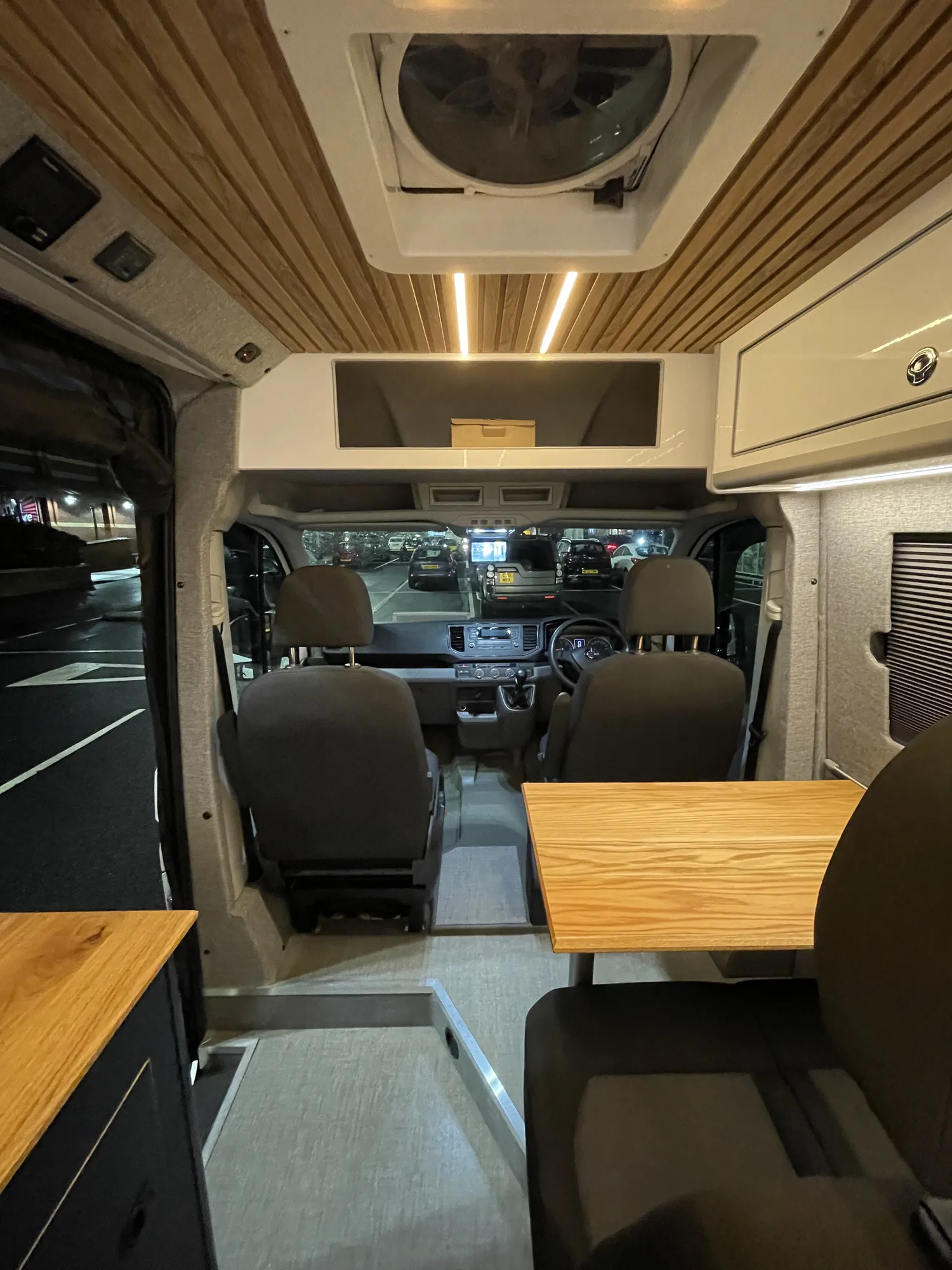 Interior of a VW Crafter conversion looking toward the cab, air-con unit above