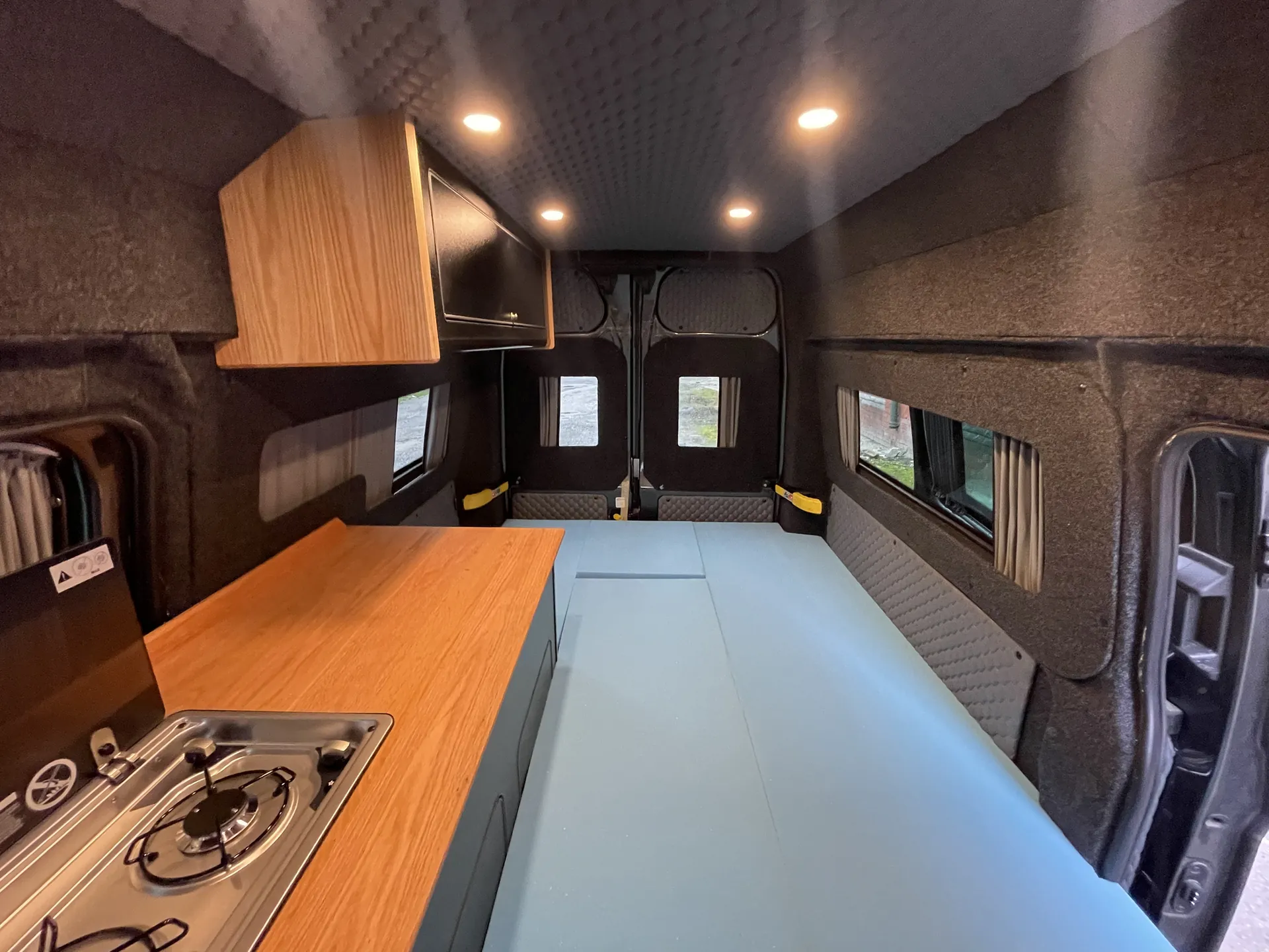 Hob, worktop and overhead lockers in a Ford Transit Custom camper