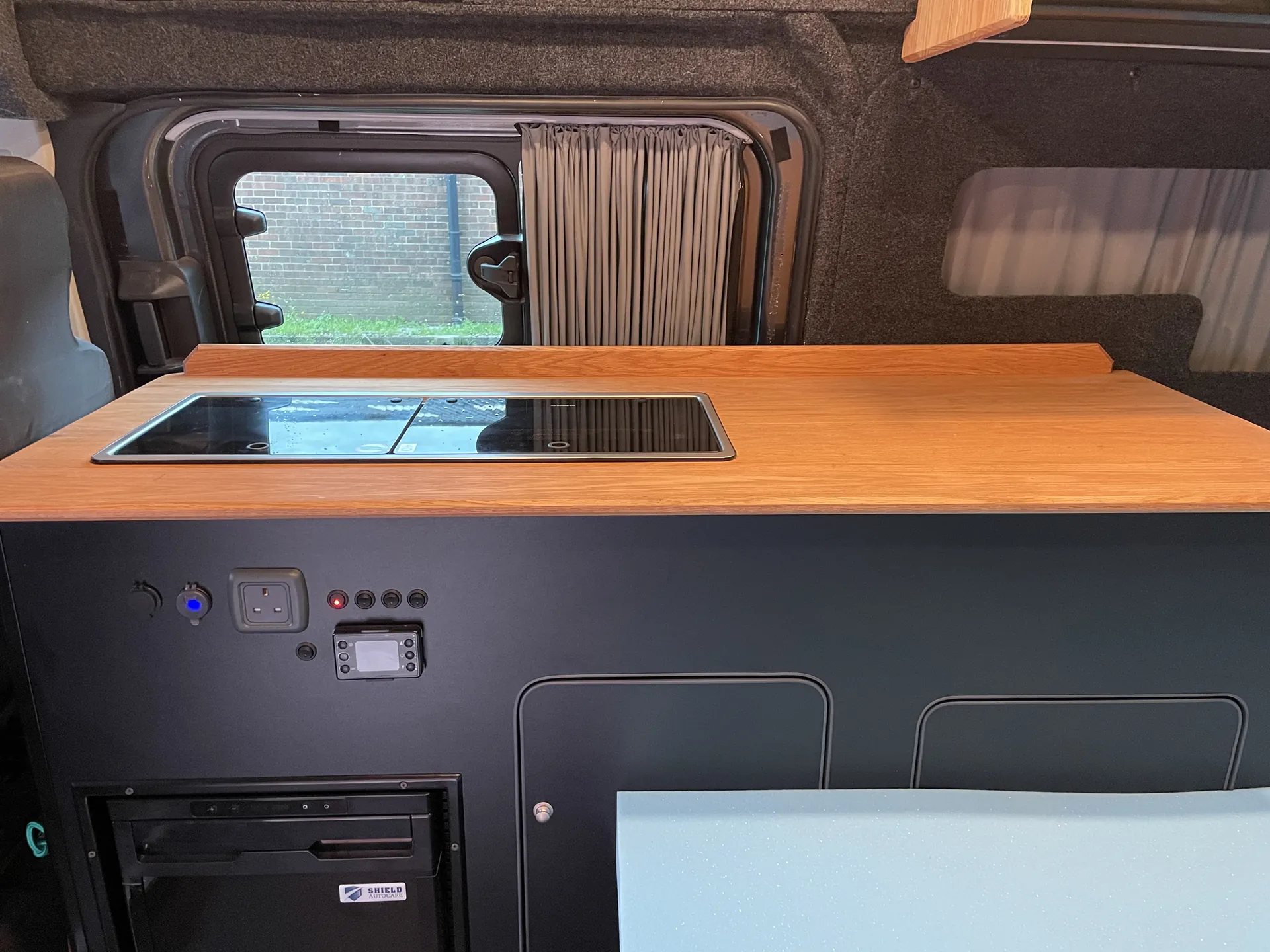 Worktop with hob and control panel in a Ford Transit Custom conversion