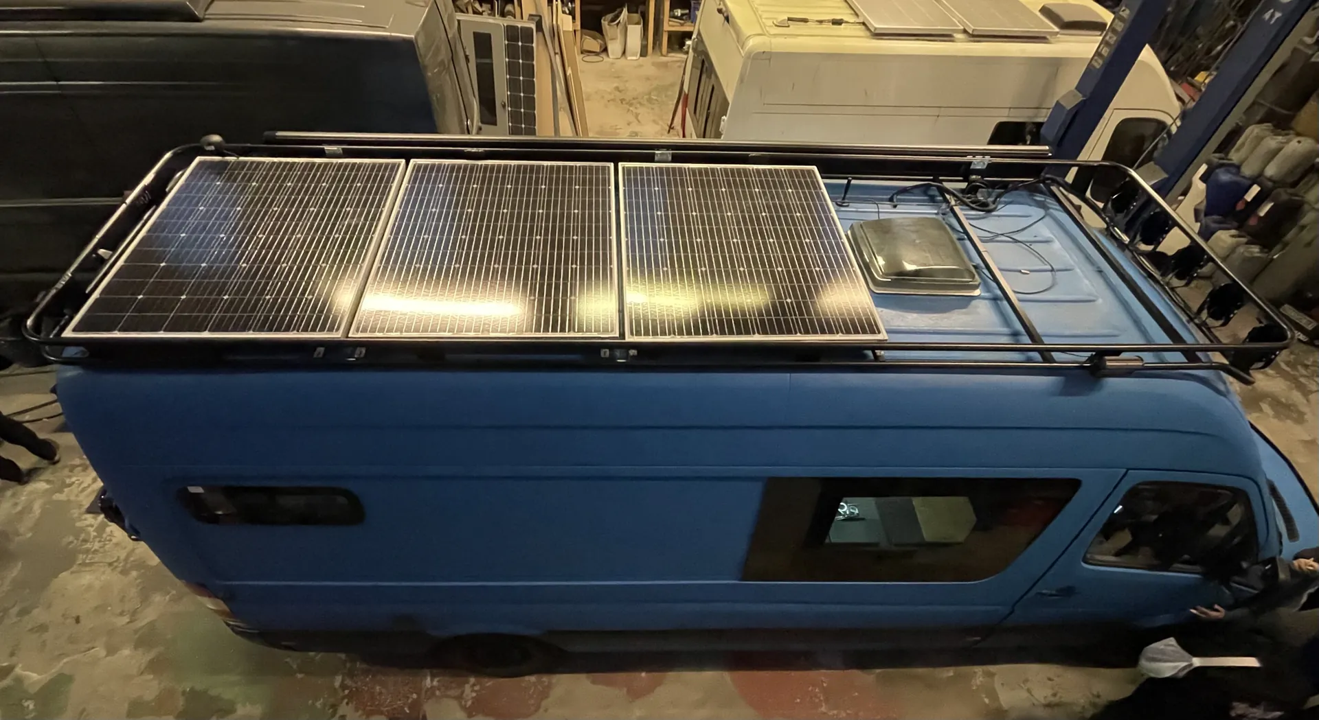 Roof rack with solar panels on a Mercedes Sprinter expedition camper